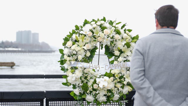 Joan Camprubí Montal, a family member of five of the victims who died in the Hudson River helicopter crash, looks at a memorial wreath on Saturday, April 12, 2025 in New York. 